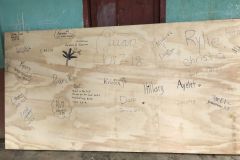 Back of whiteboard signed by team